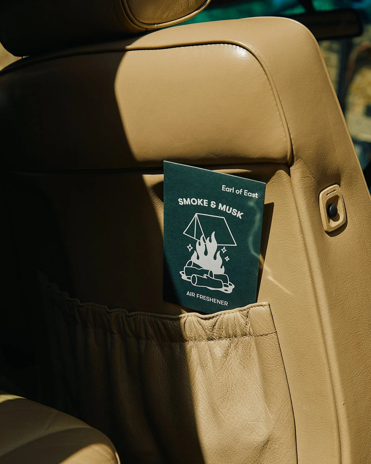 Earl of East Smoke & Musk air freshener hanging in a car